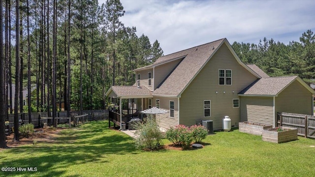 145 Cabin Branch Dr, Carthage, NC 28327 - rear view of property with a garden, roof with shingles, and a view of trees