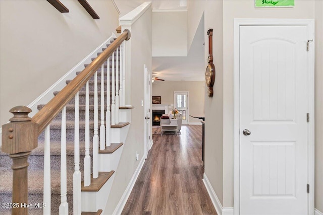 145 Cabin Branch Dr, Carthage, NC 28327 - entrance foyer featuring dark wood-style flooring, stairway, ceiling fan, baseboards, and a lit fireplace