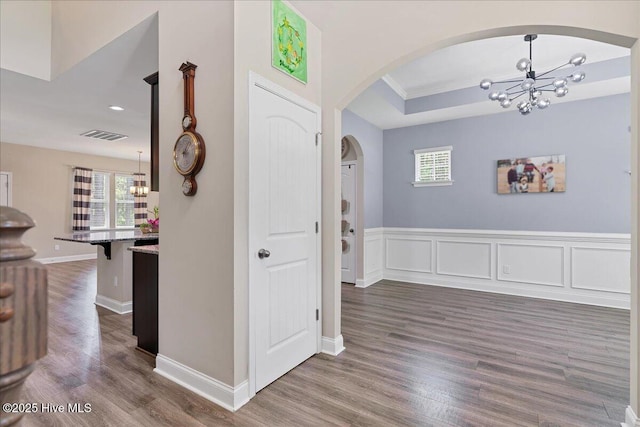 145 Cabin Branch Dr, Carthage, NC 28327 - foyer entrance featuring a chandelier, arched walkways, dark wood-style floors, a tray ceiling, and recessed lighting