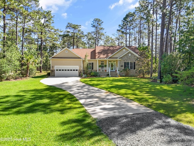 354 N Hills Dr, Southport, NC 28461 - view of front facade featuring concrete driveway, a garage, a front yard, and stone siding