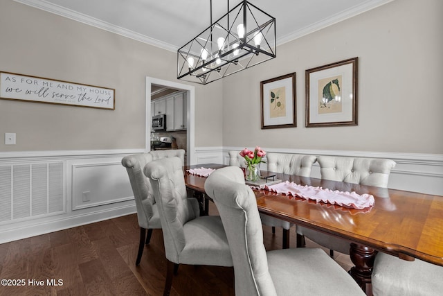 125 Steeplechase Way, Southern Pines, NC 28387 - dining room with crown molding, a chandelier, a wainscoted wall, and dark wood finished floors