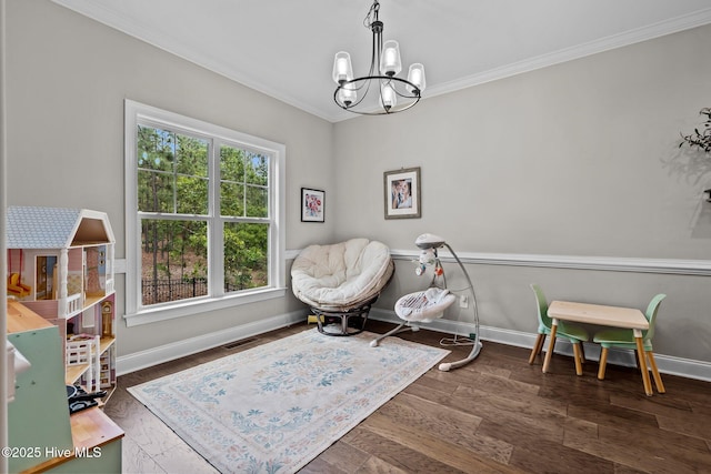 125 Steeplechase Way, Southern Pines, NC 28387 - living area featuring a chandelier, crown molding, baseboards, and wood finished floors