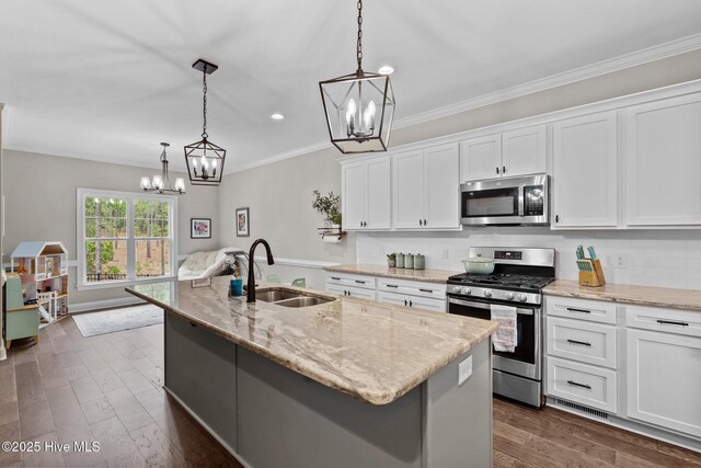 125 Steeplechase Way, Southern Pines, NC 28387 - kitchen featuring stainless steel appliances, a chandelier, a sink, white cabinetry, and light stone countertops