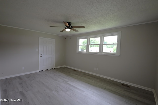 420 New River Dr, Jacksonville, NC 28540 - spare room featuring ceiling fan, a textured ceiling, wood finished floors, crown molding, and baseboards