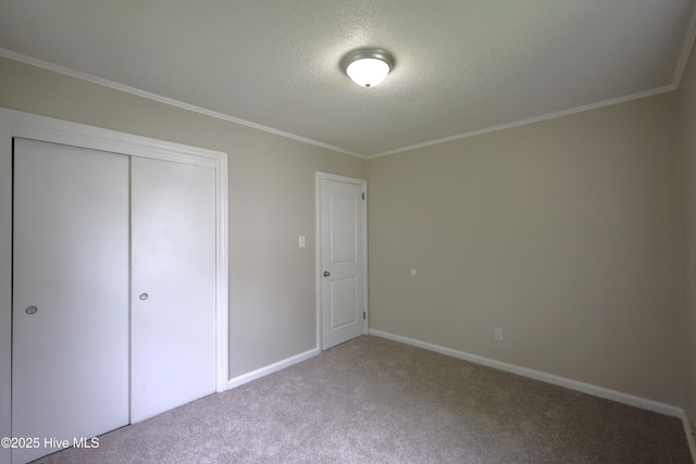 420 New River Dr, Jacksonville, NC 28540 - unfurnished bedroom with crown molding, carpet, a textured ceiling, baseboards, and a closet