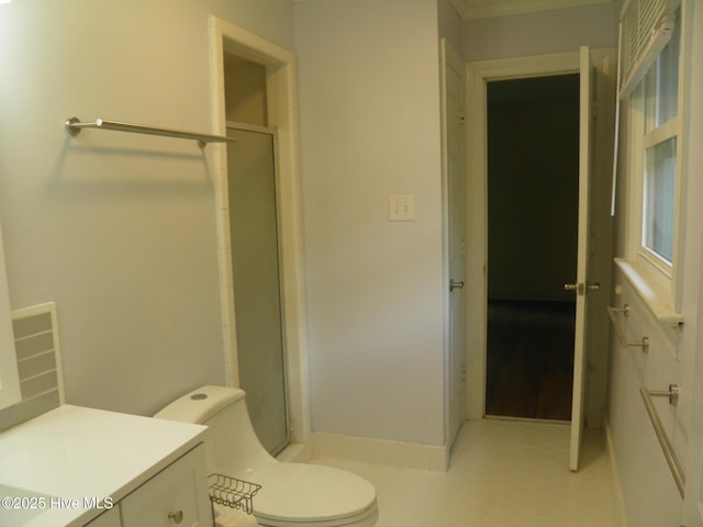bathroom with a shower stall, toilet, and vanity