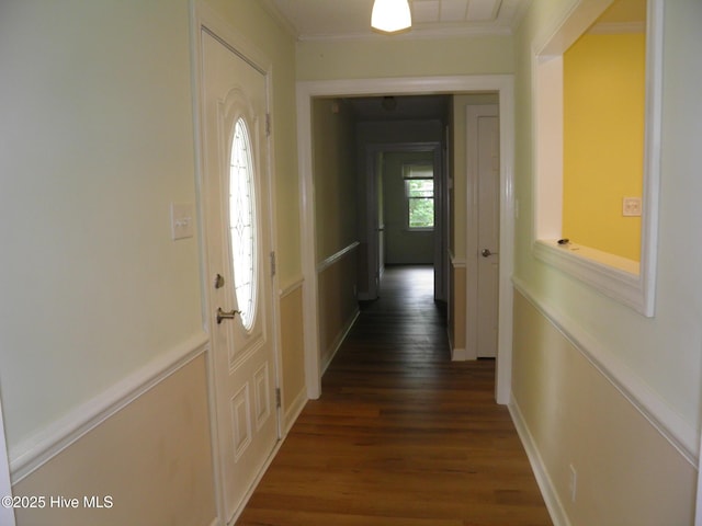 hallway featuring dark wood finished floors and ornamental molding