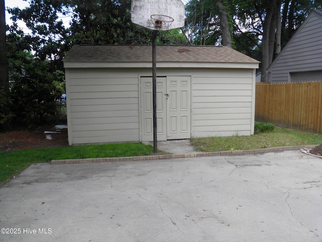 view of shed with fence