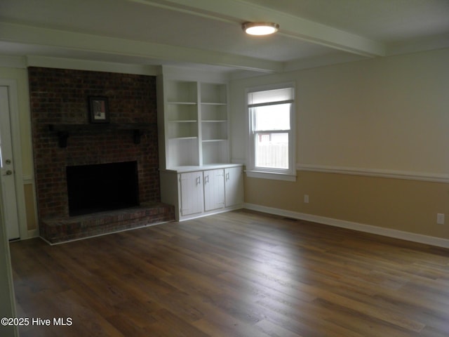unfurnished living room featuring wood finished floors, beam ceiling, baseboards, and a fireplace