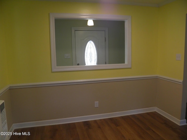 foyer featuring wood finished floors and baseboards