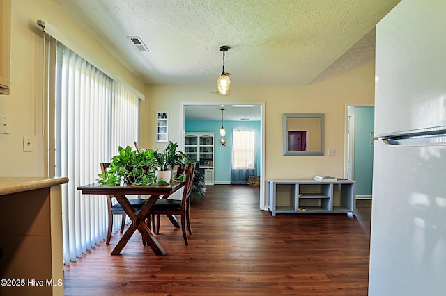 229 Red Carnation Dr, Holly Ridge, NC 28445 - dining room featuring dark wood finished floors, a textured ceiling, and baseboards