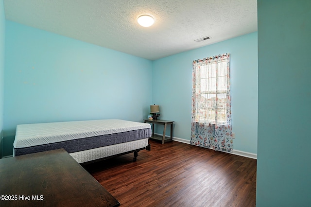 229 Red Carnation Dr, Holly Ridge, NC 28445 - bedroom featuring wood finished floors, baseboards, and a textured ceiling