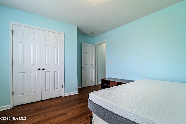229 Red Carnation Dr, Holly Ridge, NC 28445 - bedroom featuring dark wood-style flooring, a closet, and baseboards