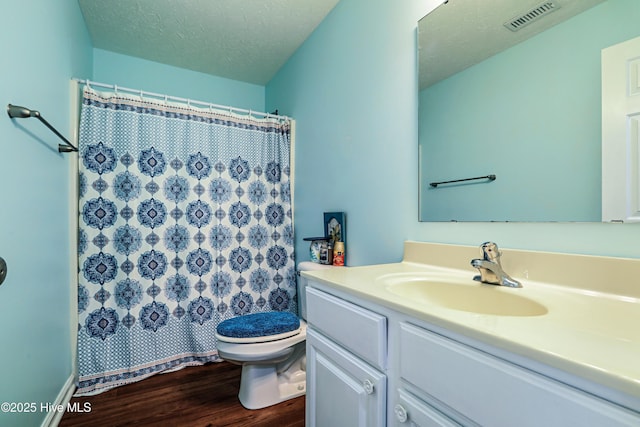 229 Red Carnation Dr, Holly Ridge, NC 28445 - bathroom featuring wood finished floors, toilet, vanity, a textured ceiling, and a shower with curtain
