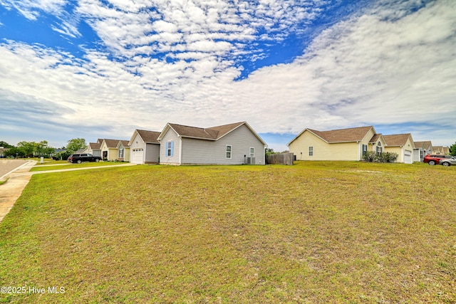 229 Red Carnation Dr, Holly Ridge, NC 28445 - view of side of home with a lawn