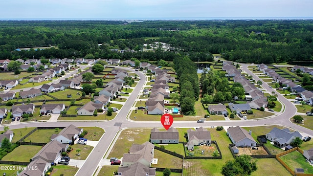 229 Red Carnation Dr, Holly Ridge, NC 28445 - aerial view of property and surrounding area with a heavily wooded area and nearby suburban area