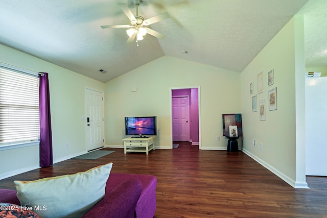229 Red Carnation Dr, Holly Ridge, NC 28445 - living room featuring wood finished floors, vaulted ceiling, ceiling fan, a textured ceiling, and baseboards
