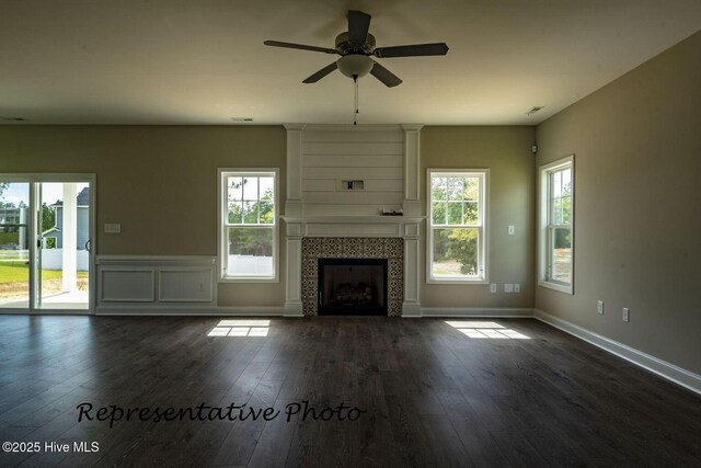 30080 Loblolly Ct, Wagram, NC 28396 - unfurnished living room with dark wood-style floors, a fireplace, and a ceiling fan