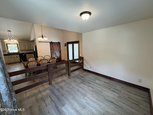 2483 Mcneill Hobbs Rd, Bunnlevel, NC 28323 - dining room with a barn door, light wood-type flooring, and baseboards