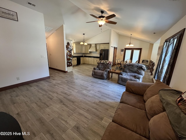 2483 Mcneill Hobbs Rd, Bunnlevel, NC 28323 - living room with a chandelier, ceiling fan, baseboards, light wood-style floors, and high vaulted ceiling