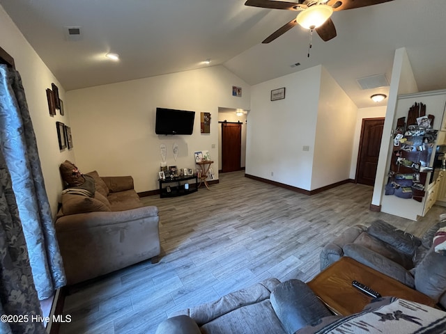 2483 Mcneill Hobbs Rd, Bunnlevel, NC 28323 - living area with lofted ceiling, ceiling fan, wood finished floors, baseboards, and a barn door