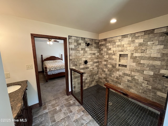 2483 Mcneill Hobbs Rd, Bunnlevel, NC 28323 - full bathroom featuring tiled shower, vanity, ensuite bathroom, ceiling fan, and stone finish floors