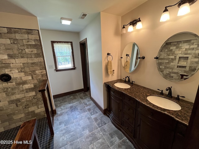 2483 Mcneill Hobbs Rd, Bunnlevel, NC 28323 - bathroom with baseboards, double vanity, stone finish flooring, and tiled shower