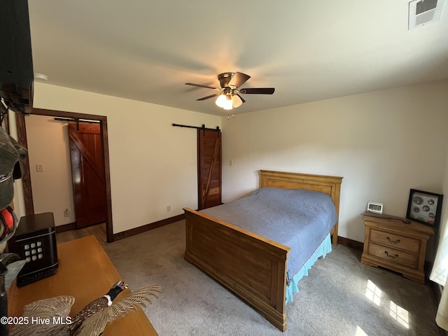 2483 Mcneill Hobbs Rd, Bunnlevel, NC 28323 - carpeted bedroom featuring a barn door, ceiling fan, and baseboards