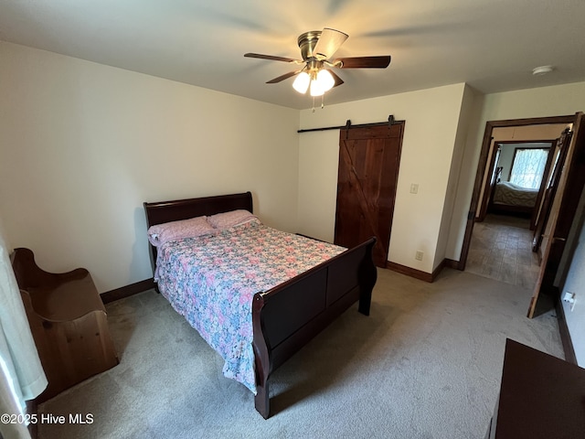 2483 Mcneill Hobbs Rd, Bunnlevel, NC 28323 - bedroom featuring light carpet, a barn door, baseboards, and a ceiling fan