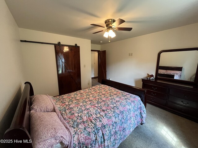 2483 Mcneill Hobbs Rd, Bunnlevel, NC 28323 - bedroom featuring carpet floors, a barn door, and a ceiling fan