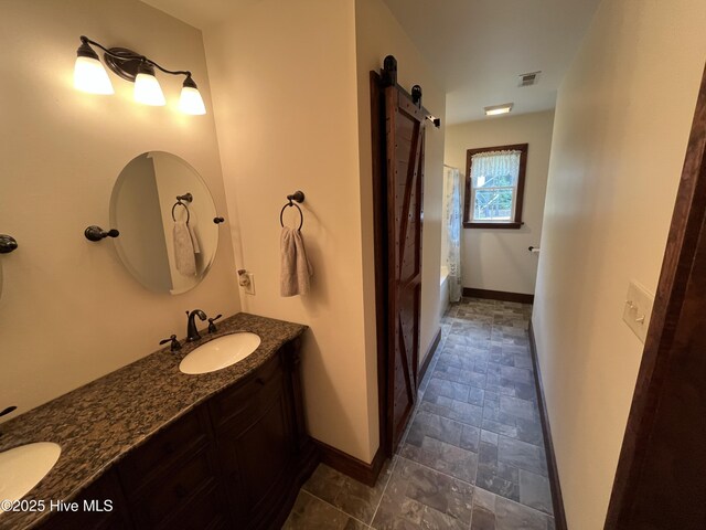 2483 Mcneill Hobbs Rd, Bunnlevel, NC 28323 - full bathroom featuring baseboards, shower / tub combo, double vanity, and stone finish flooring