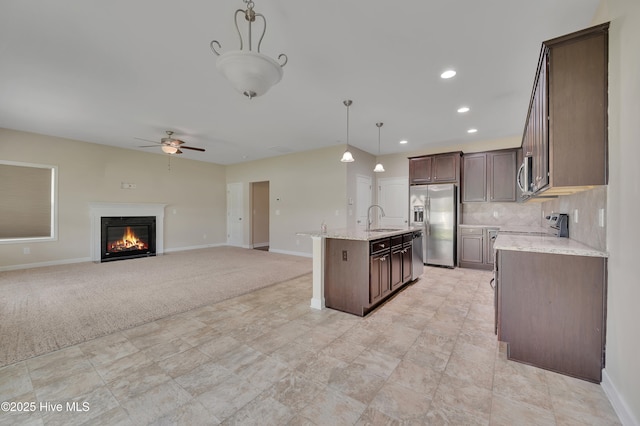 1232 Teakwood Dr, Greenville, NC 27834 - kitchen featuring a sink, appliances with stainless steel finishes, a ceiling fan, baseboards, and dark brown cabinets