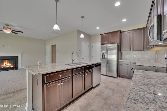 1232 Teakwood Dr, Greenville, NC 27834 - kitchen with stainless steel appliances, a sink, ceiling fan, decorative backsplash, and open floor plan