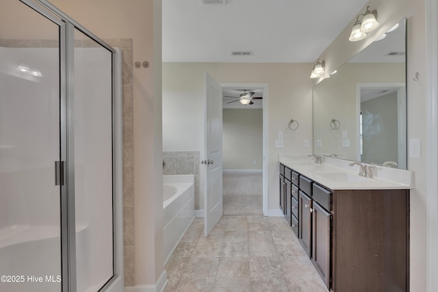 1232 Teakwood Dr, Greenville, NC 27834 - bathroom featuring a ceiling fan, a shower stall, a bath, double vanity, and baseboards
