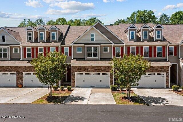 270 Wembley Dr, Clayton, NC 27527 - view of property with an attached garage, driveway, and stone siding