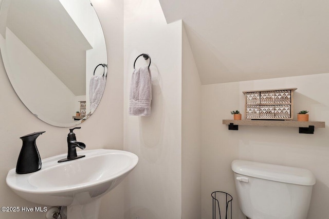 270 Wembley Dr, Clayton, NC 27527 - bathroom with a sink, toilet, and vaulted ceiling