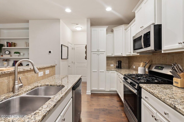 270 Wembley Dr, Clayton, NC 27527 - kitchen with stainless steel appliances, a sink, dark wood finished floors, tasteful backsplash, and white cabinetry