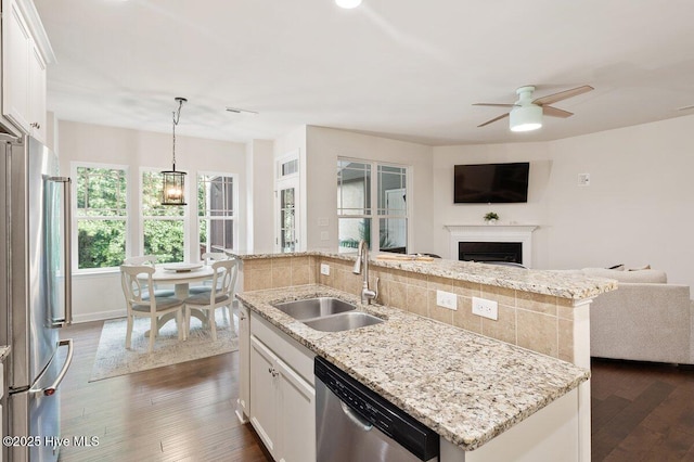 270 Wembley Dr, Clayton, NC 27527 - kitchen featuring stainless steel appliances, open floor plan, a sink, a kitchen island with sink, and decorative backsplash