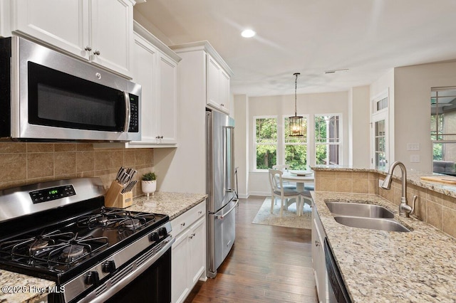 270 Wembley Dr, Clayton, NC 27527 - kitchen featuring stainless steel appliances, a sink, healthy amount of natural light, white cabinetry, and recessed lighting