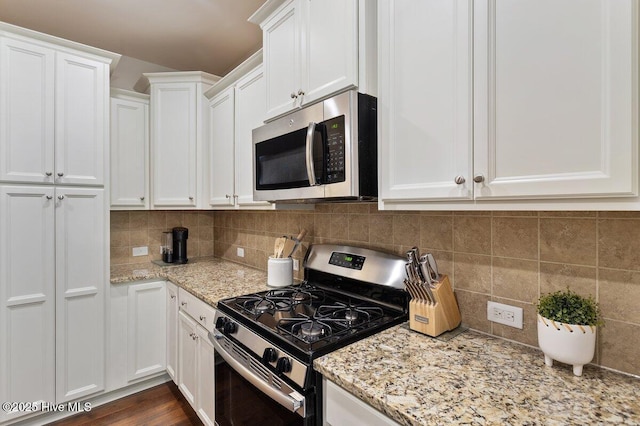 270 Wembley Dr, Clayton, NC 27527 - kitchen with appliances with stainless steel finishes, white cabinets, light stone countertops, and backsplash