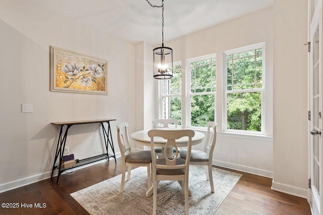 270 Wembley Dr, Clayton, NC 27527 - dining area with baseboards, a chandelier, and dark wood-style floors