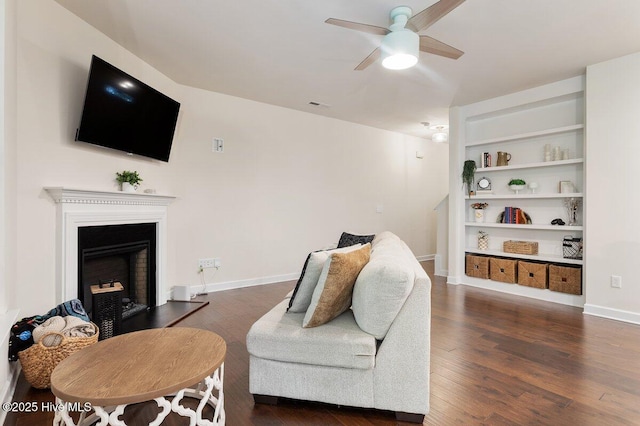 270 Wembley Dr, Clayton, NC 27527 - living room with a ceiling fan, wood finished floors, a fireplace with raised hearth, and baseboards