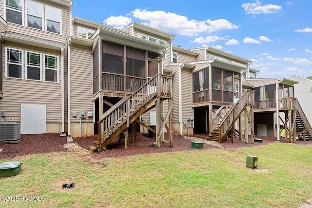270 Wembley Dr, Clayton, NC 27527 - back of house featuring a sunroom, stairs, central AC, and a lawn