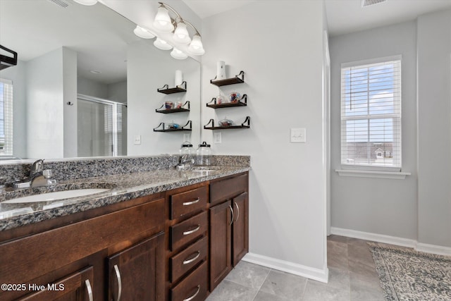 137 Gander Dr, Moyock, NC 27958 - full bathroom featuring healthy amount of natural light, a stall shower, double vanity, and baseboards