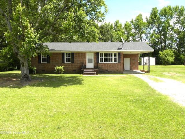 210 Russell Dr, Princeville, NC 27886 - ranch-style home featuring driveway, crawl space, a front yard, brick siding, and a carport
