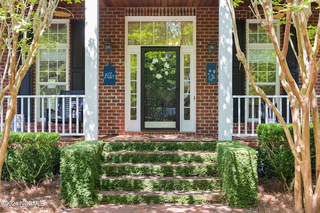6920 Runningbrook Ter, Wilmington, NC 28411 - view of exterior entry with brick siding and covered porch