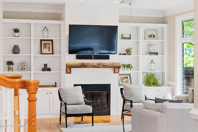 6920 Runningbrook Ter, Wilmington, NC 28411 - living room with a fireplace, wood finished floors, ornamental molding, and built in shelves