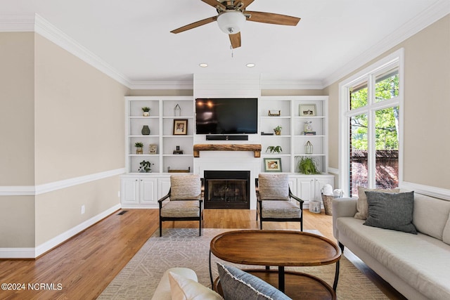 6920 Runningbrook Ter, Wilmington, NC 28411 - living room with a large fireplace, wood finished floors, crown molding, ceiling fan, and recessed lighting