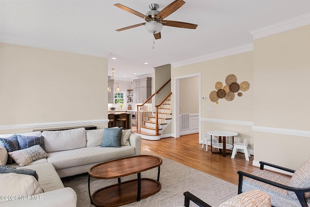 6920 Runningbrook Ter, Wilmington, NC 28411 - living room featuring stairway, a ceiling fan, ornamental molding, light wood-style flooring, and recessed lighting