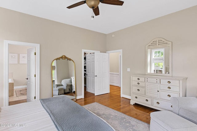 6920 Runningbrook Ter, Wilmington, NC 28411 - bedroom featuring wood finished floors, multiple windows, a spacious closet, and ensuite bathroom